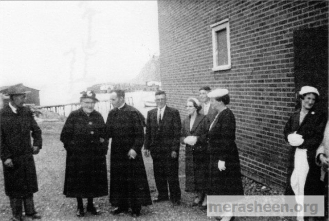 From the left : man in the hat is Casimir Doody (Fr. Jim Doody's father); Jane (Hann) Pomeroy (half sister of Din Pat Walsh) ; Father James Doody ; Din Pat Walsh; Mary Ellen (Mamie)(Ennis) Walsh; Ernie Walsh; Stella (Walsh) Best (half sister of Jane &amp;amp; sister&amp;nbsp;of Din Pat); Ethis (Ennis) Best sister of Mamie. Ethie is talking to Mrs Mary Best. Taken 16 June 1959 after Fr Denis Walsh's 1st mass in Merasheen and reception &amp;amp; dinner in Parish Hall.