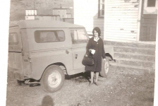 Doreen (Power) Ennis in front of Father Power's jeep 1965
