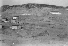 13 Across Tom Best's meadow with ballgame in progress. In the foreground: Clem Best's house; behind that is Lar Pitcher's house (built by Tom Best); behind that is Angus Pitcher's house (occupied by Joe Connors and Lambert Connors previously).&amp;nbsp; To the right is Tom Best's meadow (looks like a game of rounders being played!).&amp;nbsp; The wire fence separates the Priest's meadow and that fence was to keep the sheep out of the Priest's Meadow and to keep Monsignor Fyme's goats from getting out, which didn't always work...(He had yokes around the necks of the bigger ones to keep them from jumping the fence, but once in a while one escaped).